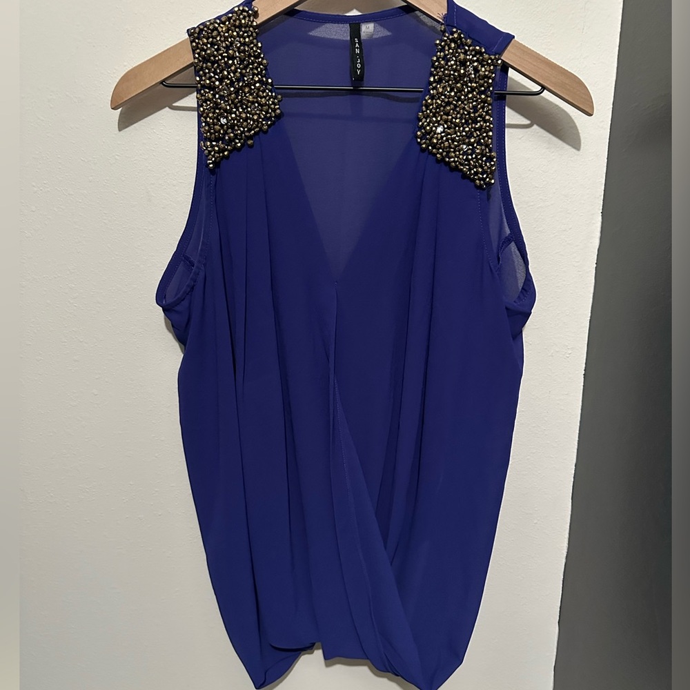 Dark blue tank with gold accents.